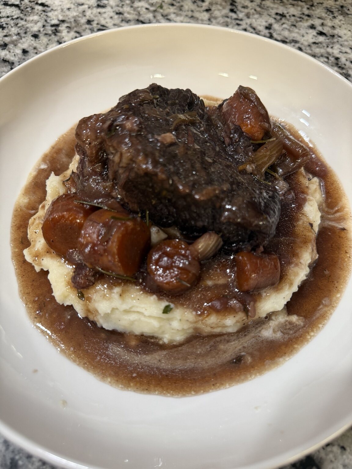 Braised entree served over mashed potatoes