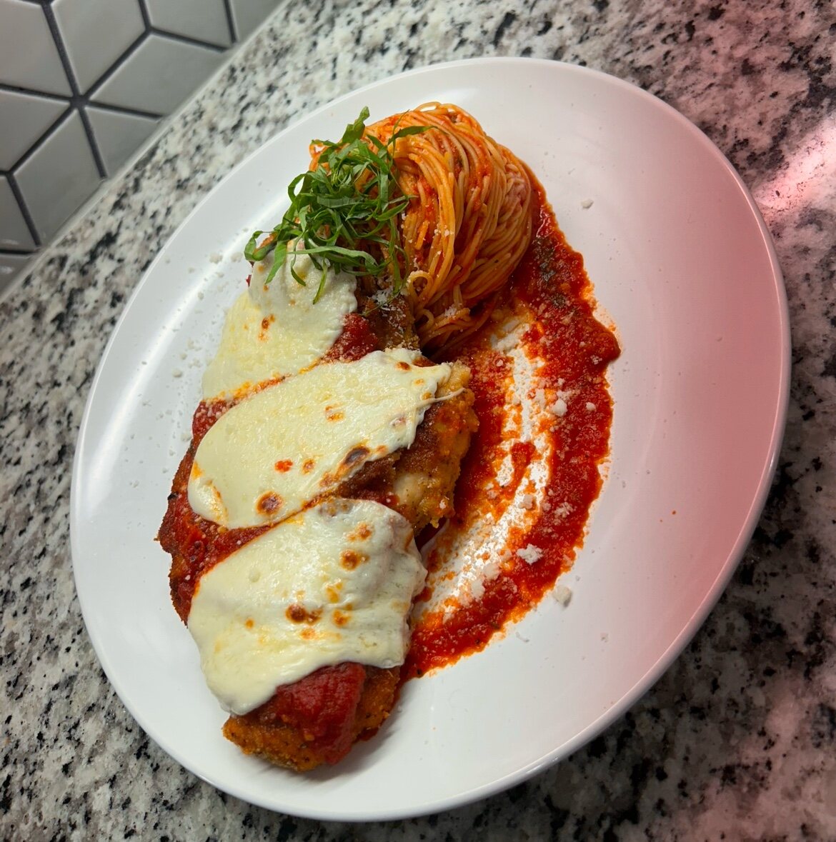 Plated pasta entree with a rich red sauce